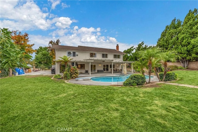 rear view of property with a lawn and a patio area