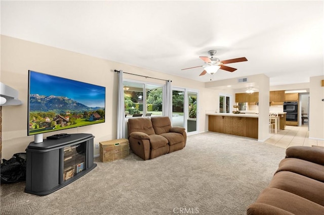 living room featuring light colored carpet and ceiling fan