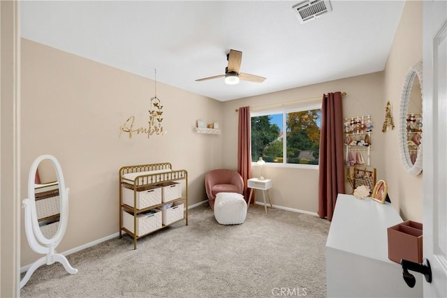 living area featuring carpet flooring and ceiling fan with notable chandelier