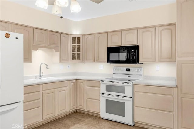 kitchen featuring light brown cabinets, white appliances, light hardwood / wood-style floors, and sink