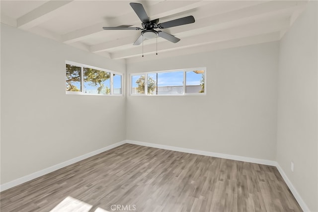 empty room with ceiling fan, light hardwood / wood-style flooring, and beamed ceiling