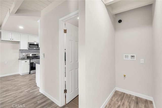 hallway with beamed ceiling and light wood-type flooring