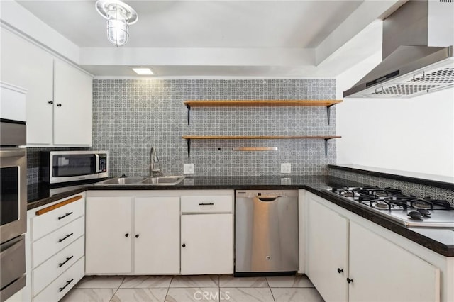 kitchen featuring appliances with stainless steel finishes, white cabinetry, wall chimney exhaust hood, and open shelves