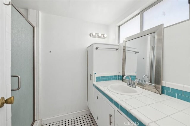 full bathroom featuring a stall shower and vanity