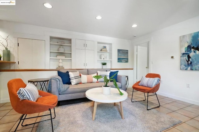 living room featuring built in features and light tile patterned flooring