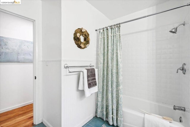 bathroom with tile patterned flooring and shower / bath combo