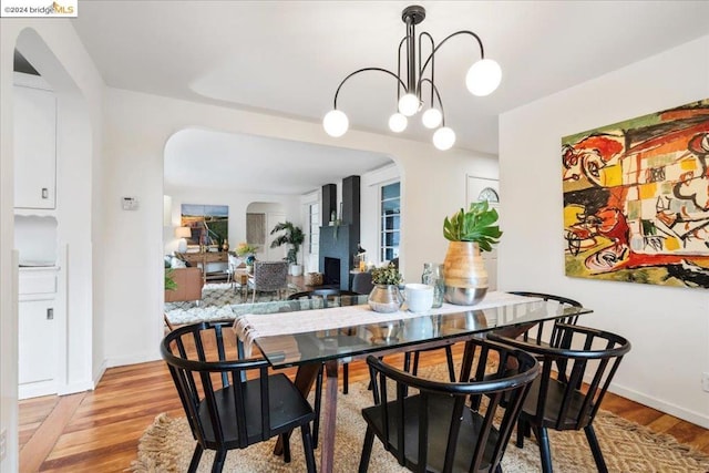 dining area with a chandelier and light wood-type flooring