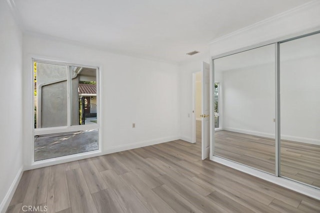 unfurnished bedroom with a closet and light hardwood / wood-style flooring