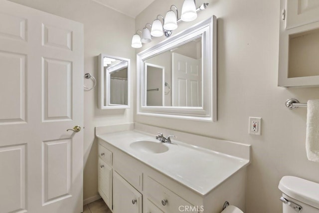 bathroom featuring tile patterned floors, toilet, and vanity