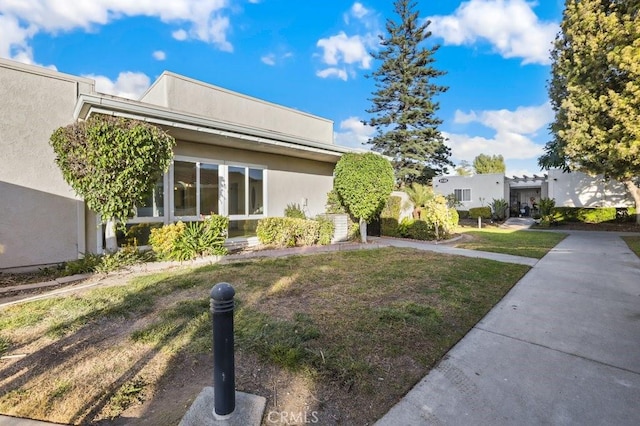 view of side of home featuring a lawn