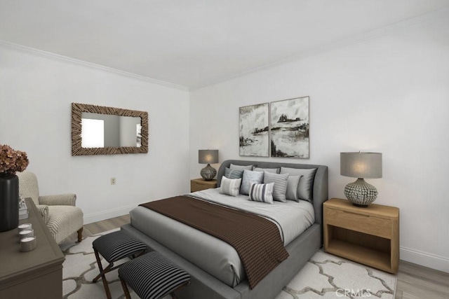 bedroom featuring crown molding and light hardwood / wood-style floors