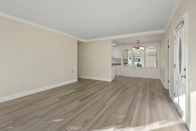 unfurnished living room featuring crown molding, a chandelier, and light wood-type flooring