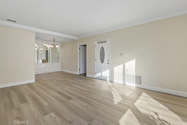 interior space featuring a chandelier, ornamental molding, and light hardwood / wood-style flooring