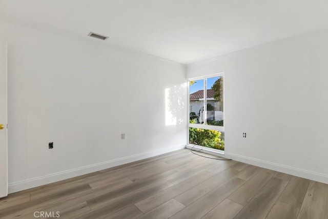 unfurnished room with light hardwood / wood-style flooring