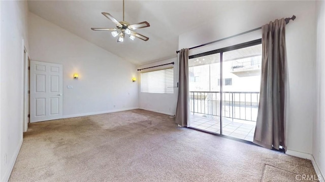 carpeted spare room featuring ceiling fan and high vaulted ceiling