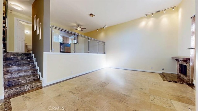 unfurnished living room featuring ceiling fan