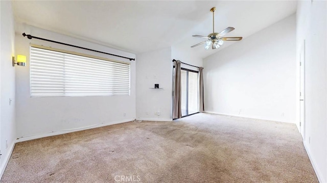 empty room featuring vaulted ceiling, ceiling fan, and light colored carpet