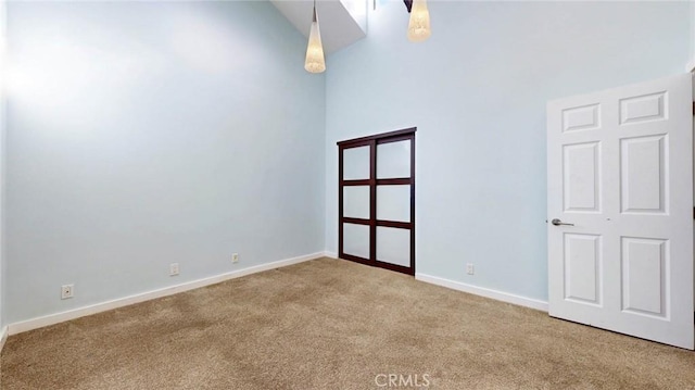 carpeted empty room with lofted ceiling