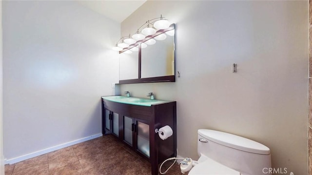 bathroom featuring toilet and vanity