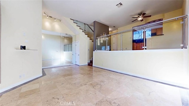 interior space with ceiling fan