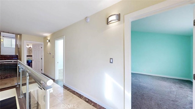 hallway featuring light colored carpet