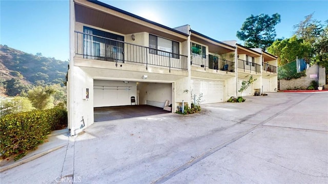 multi unit property featuring a garage and a mountain view