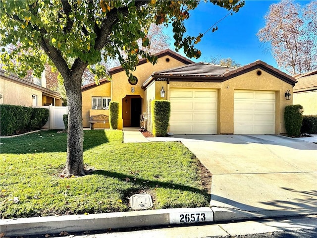 view of front of property featuring a garage and a front yard