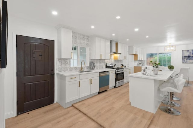 kitchen featuring sink, white cabinetry, appliances with stainless steel finishes, and light wood-type flooring