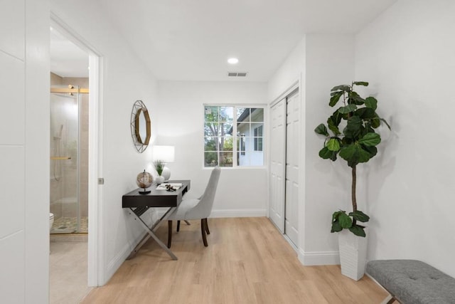 home office with light hardwood / wood-style floors