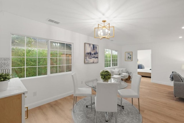 dining room featuring a chandelier and light hardwood / wood-style flooring