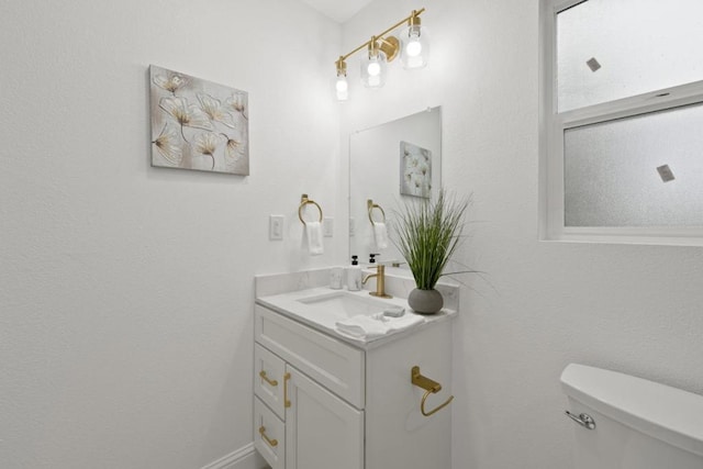 bathroom featuring toilet and vanity