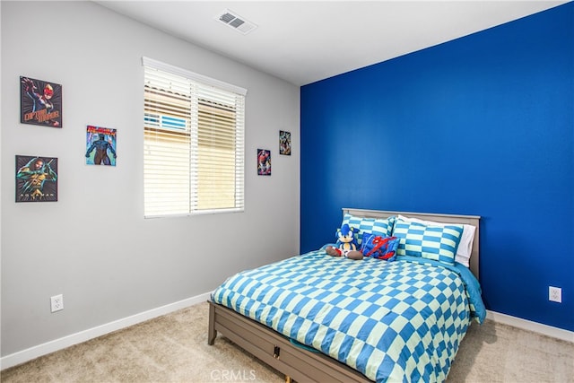 carpeted bedroom featuring baseboards and visible vents