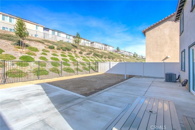 view of patio featuring central AC unit and fence
