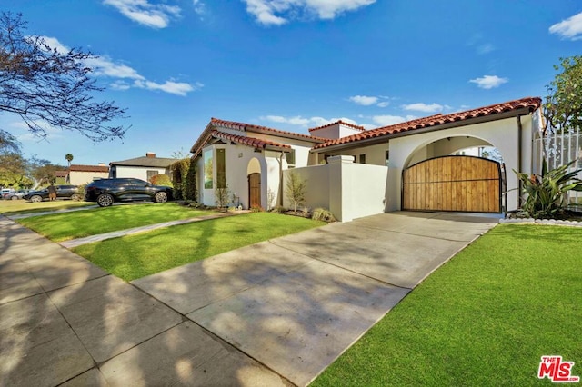 mediterranean / spanish-style house with a front lawn