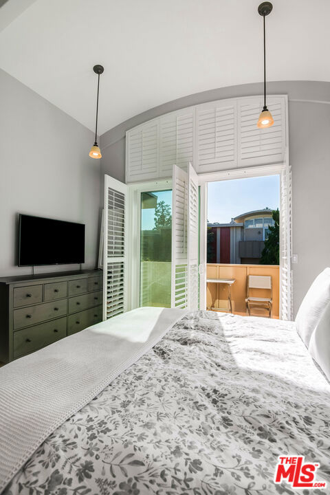 bedroom featuring access to exterior and lofted ceiling