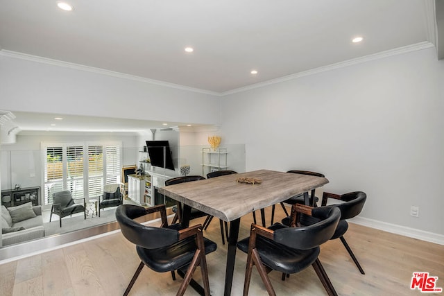 dining room with light hardwood / wood-style floors and ornamental molding