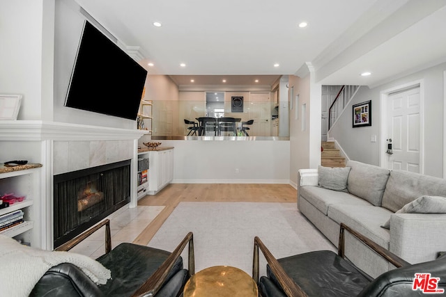 living room with a fireplace and light hardwood / wood-style floors