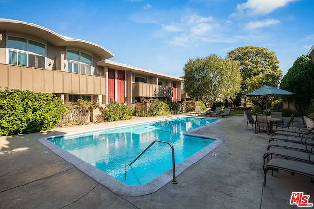 view of swimming pool featuring a patio area