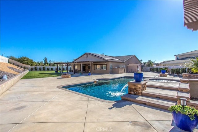 view of swimming pool featuring pool water feature, a jacuzzi, and a patio