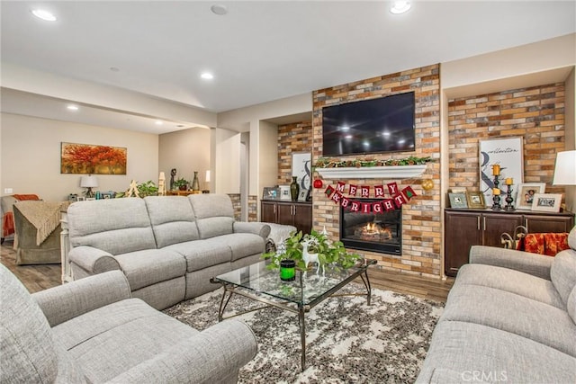 living room with hardwood / wood-style flooring and a fireplace