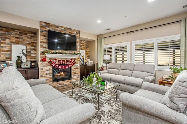 living room featuring a fireplace and wood-type flooring