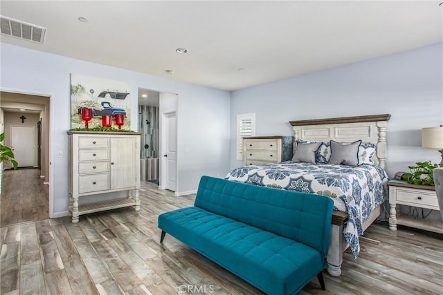 bedroom with hardwood / wood-style flooring