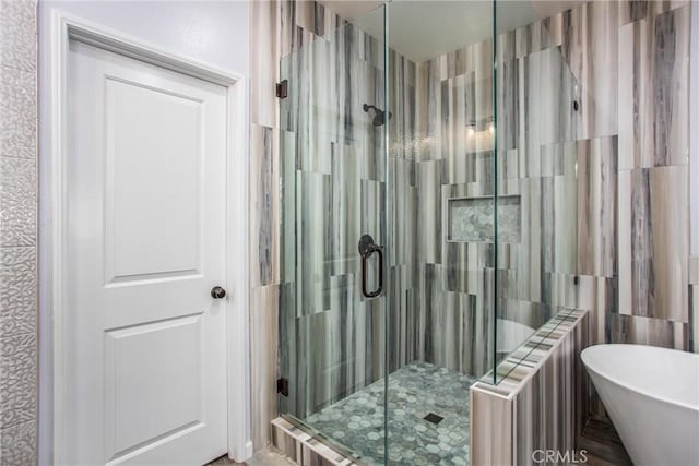 bathroom featuring separate shower and tub, radiator heating unit, and tile walls