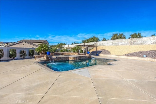 view of pool with a patio, pool water feature, and an in ground hot tub