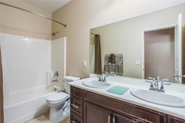 full bathroom with vanity, shower / bathtub combination with curtain, and toilet