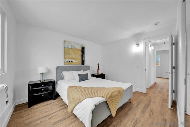 bedroom with hardwood / wood-style flooring