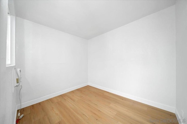 spare room with hardwood / wood-style floors