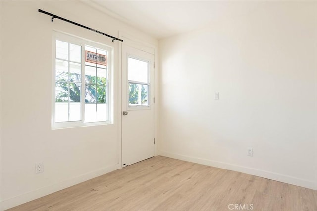 doorway to outside featuring light wood-type flooring and a healthy amount of sunlight