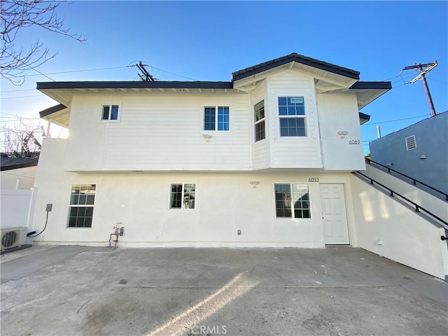 back of property featuring a patio area and ac unit