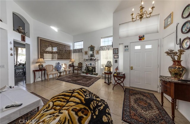 foyer entrance with an inviting chandelier and light tile patterned floors